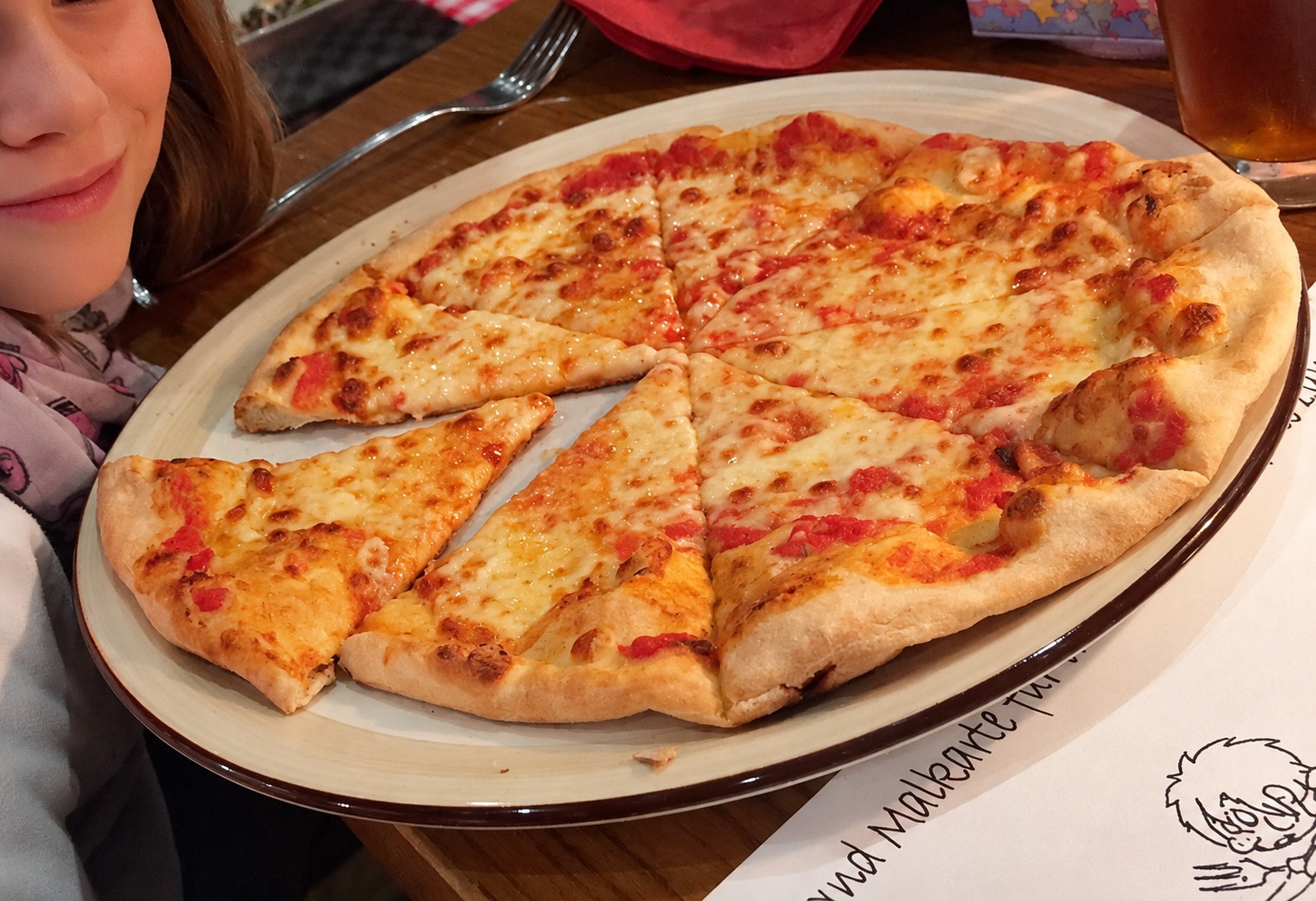 A freshly sliced pizza Margherita on the table