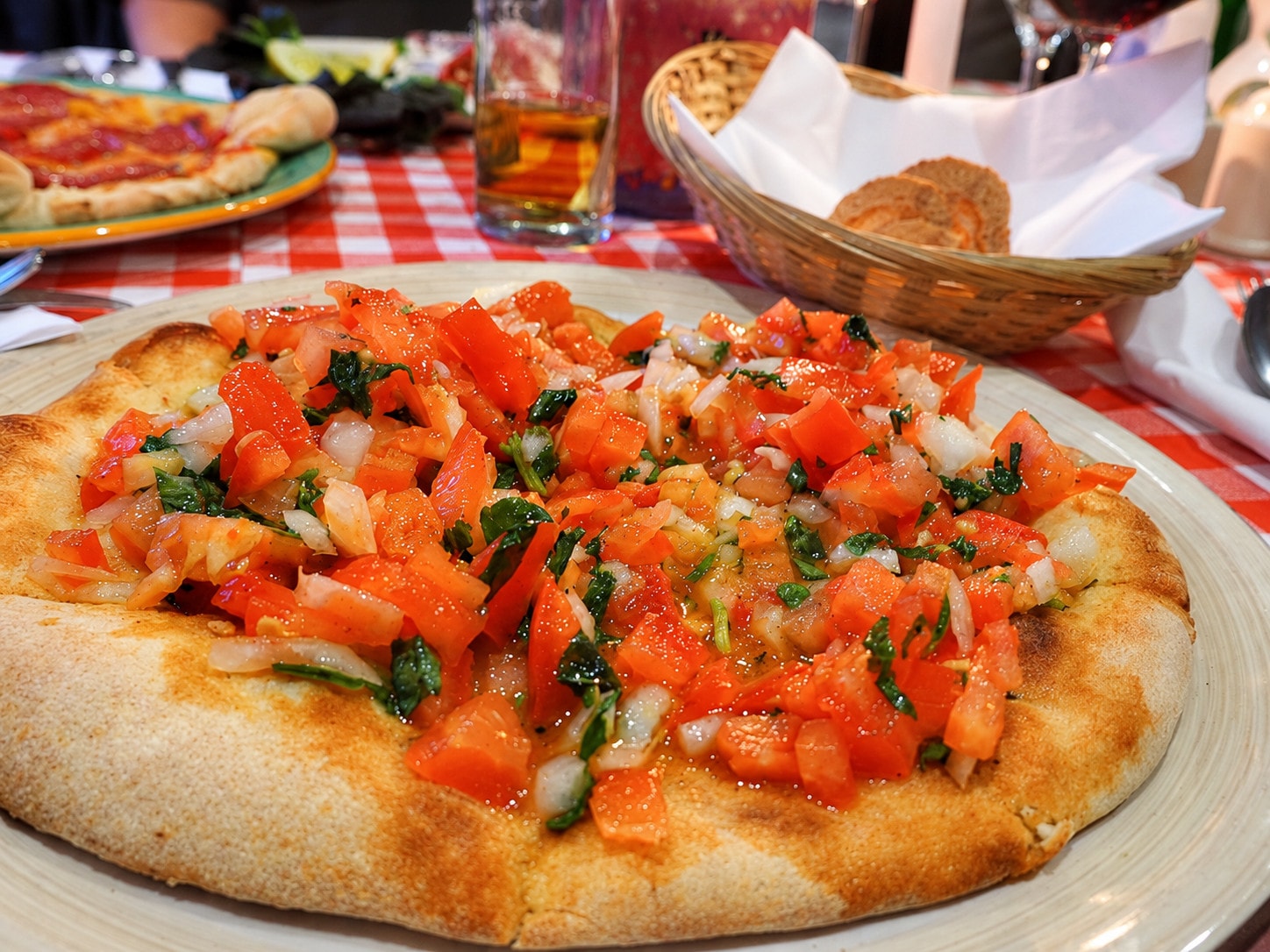 Pizza bread topped with fresh diced tomato, garlic and herbs