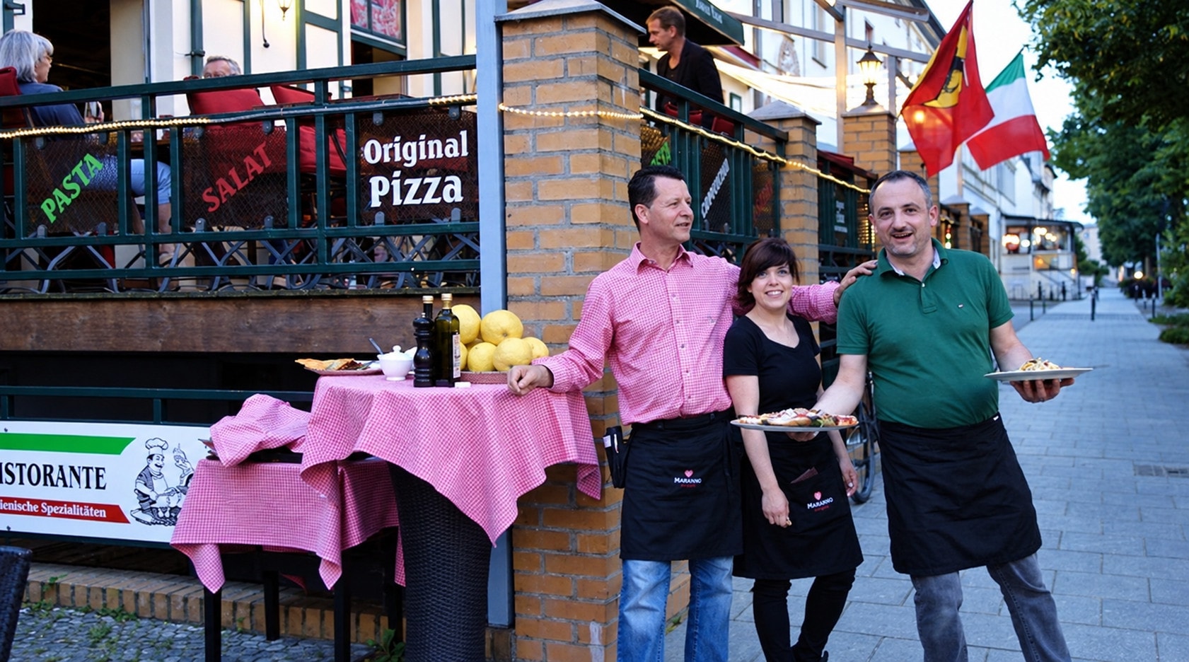 The Pane e Vino team in front of the terrace, plates in hand