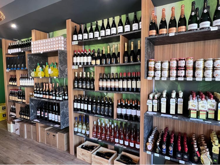 A wall of shelves full of Italian wines